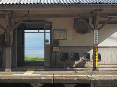 an empty train station with the doors open