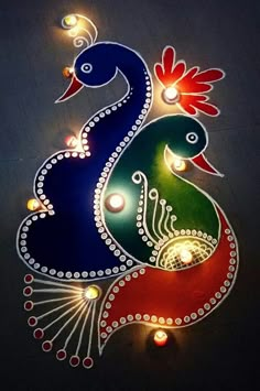 an artistic painting on the wall with lights and candles in it, depicting two peacocks