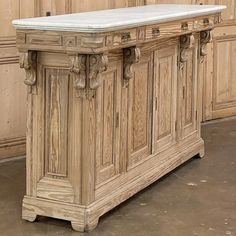 an old wooden cabinet with marble top