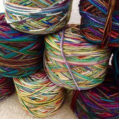 several skeins of multicolored yarn are stacked on top of each other