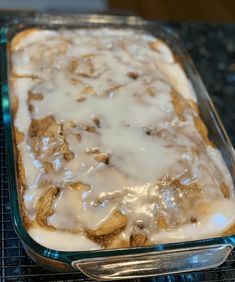 a glass baking dish filled with some kind of food on top of a cooling rack