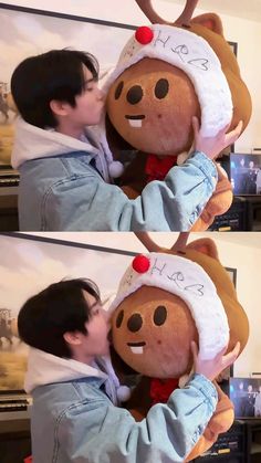 a man kissing a large stuffed animal wearing a santa hat