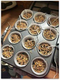 muffin tins filled with granola sitting on top of a stove