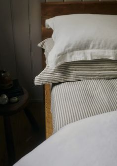 a bed with two pillows and white sheets