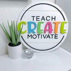 a sign that says teach create motivate next to a potted plant