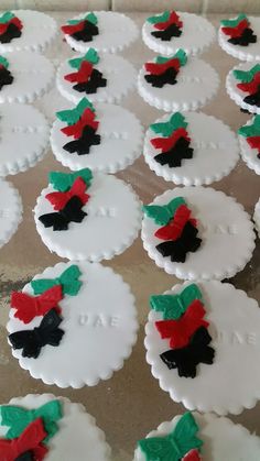 frosted cookies decorated with red, black and green bows