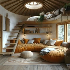 a living room filled with lots of furniture next to a wooden floor covered in pillows