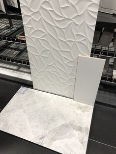 a white tile wall next to an oven in a kitchen