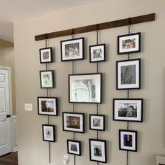 a living room with pictures hanging on the wall