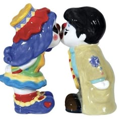 two ceramic figurines that look like they are kissing