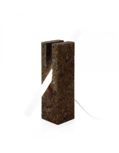 an object made out of cork with a white ribbon tied to it's end