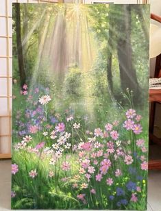 an easel with flowers and sunlight shining through the trees on it's side