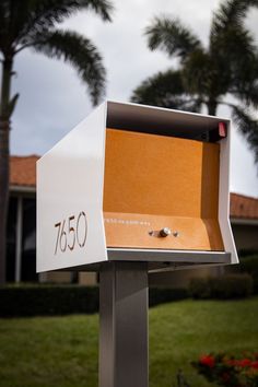 a mailbox with the number 7500 on it in front of some palm trees