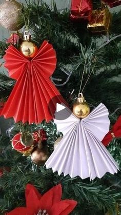 christmas tree decorated with red and white paper fan ornament, bells and ornaments