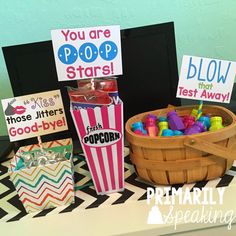 there are some popcorn boxes and signs on the table with candy in them that say you are poop stars