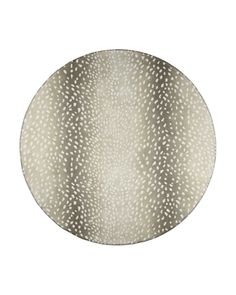 a white and silver plate sitting on top of a white tablecloth covered in dots