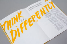 an open book with the words think differently written in yellow on it's cover