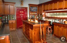 a large kitchen with wooden cabinets and black counter tops, along with tile flooring