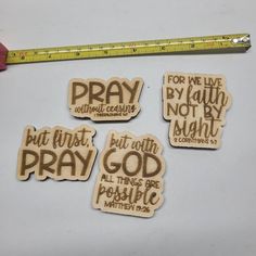 four wooden magnets with the words pray, but first, not by night and all that is possible written on them