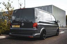 a grey van parked on the side of a road