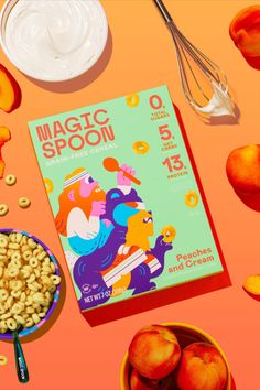 the book magic spoon is next to some peaches and cream on an orange background