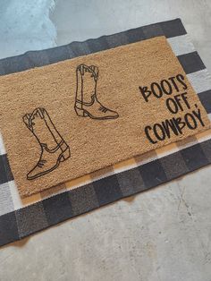 a door mat with boots on it and the words boots off cowboy written in black ink