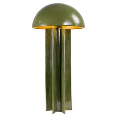 a green lamp that is on top of a white wall and has two lights attached to it