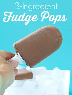 an ice cream popsicle being dipped with chocolate and marshmallows on a blue background