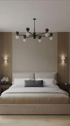 a large bed sitting under a chandelier in a bedroom next to a window