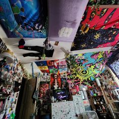 a room filled with lots of different types of art on the walls and ceiling above it