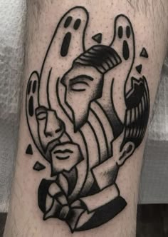 a man's leg with a black and white tattoo design on his arm,