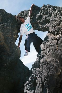 a man jumping off rocks into the air