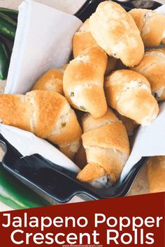 some bread rolls are in a basket on the table