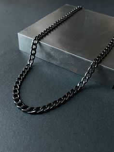 Our stainless steel curb chain is made from premium quality 316L stainless steel. This stunning piece of jewelry is not only made from high-quality stainless steel, but it also features a mesmerizing black finish that will draw attention wherever you go. The classic curb link design adds an extra layer of sophistication to the already unique dark aesthetic of this chain. The chain is durable and made for everyday wear. Stainless steel is hypoallergenic, resistant to tarnishing and waterproof! Ma Black Figaro Chain Necklace As Gift, Black Figaro Chain Jewelry, Black Figaro Chain Necklace Gift, Black Figaro Chain Necklace For Gift, Minimalist Black Chain Link Jewelry, Black Cuban Link Jewelry With Curb Chain, Black Curb Chain Jewelry For Gift, Black Necklace With Adjustable Chain, Black Adjustable Chain Necklace