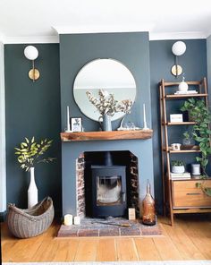 a living room filled with furniture and a fire place in front of a round mirror