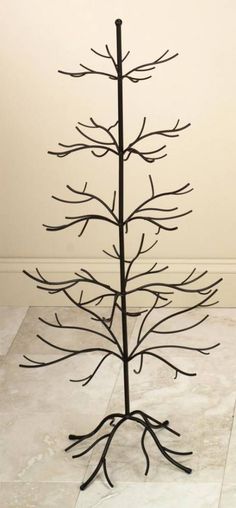 a metal tree is standing on the floor