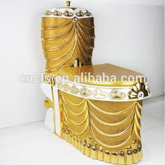 an elaborately designed toilet in gold and white