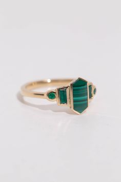 Art deco inspired ring with malachite and natural emeralds. Malachite is inlaid into the elongated hexagon, measuring 9.5mm x 5mm. Vibrant green accent emeralds are approximately .30 total carat worth. Millimeter measurement from end to end is 15mm. Your choice of gold color and karat. Band is 1.75mm thick. Please leave a note at checkout with your preferred size. All gems and rocks are nuanced in color, please know that your ring will be very similar to the pictured ring, but unique in it's own Malachite Rings, All Gems, Green Accents, Mirror Mirror, Art Deco Inspired, Vibrant Green, Recycled Gold, Natural Emerald, Yellow Roses