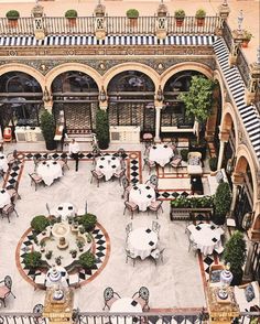 an aerial view of a courtyard with tables and chairs set up for a formal function