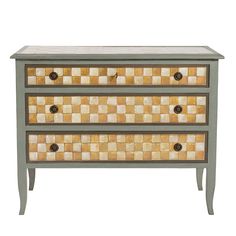 an old dresser with two drawers painted in yellow and brown checkerboard pattern on it