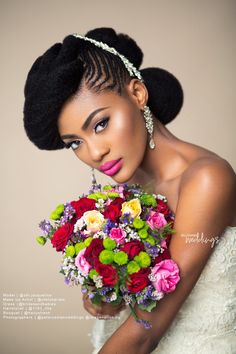 a woman in a wedding dress holding a bouquet of flowers and wearing a tiara