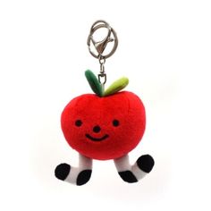 a red apple keychain hanging from a metal hook