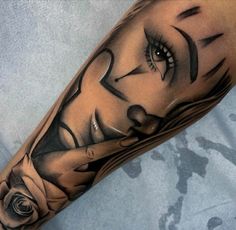 a woman's face with black and grey lines on her arm, in the shape of a rose