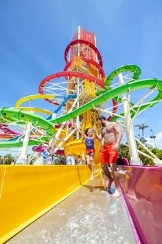 a man standing on top of a water slide