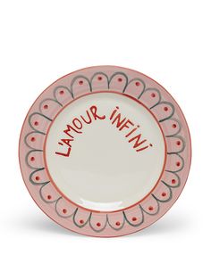 a pink and white plate with the words latour infw written on it