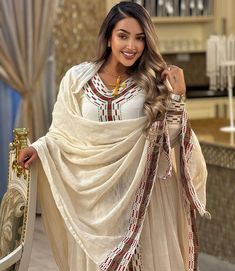 Get this dress for extra luxury for it has a long, flowing design with a modest, and elegant cut. This dress is often worn for special occasions such as religious ceremonies, weddings, or cultural celebrations Material Cotton Thread Estimated delivery : 2weeks to 3weeks Contact WhatsApp +1(304)-306-2784Email: contact@ethiopian.store Eritrean Dress, Habesha Dress, Ethiopian Traditional Dress, Ethiopian Dress, Habesha Kemis, Indigenous Tribes, Traditional Embroidery, Flow Design, Wedding Dress Chiffon