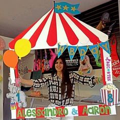 a woman standing in front of a circus tent