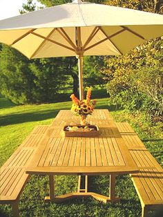 a wooden table with an umbrella over it