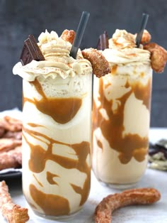 two glasses filled with ice cream and caramel