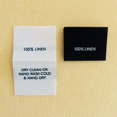 two labels on the side of a refrigerator door that say 100 % linen and clean or hand wash cold and hang dry